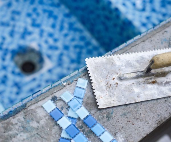 Blue mosaic tiles on a swimming pool in construction.